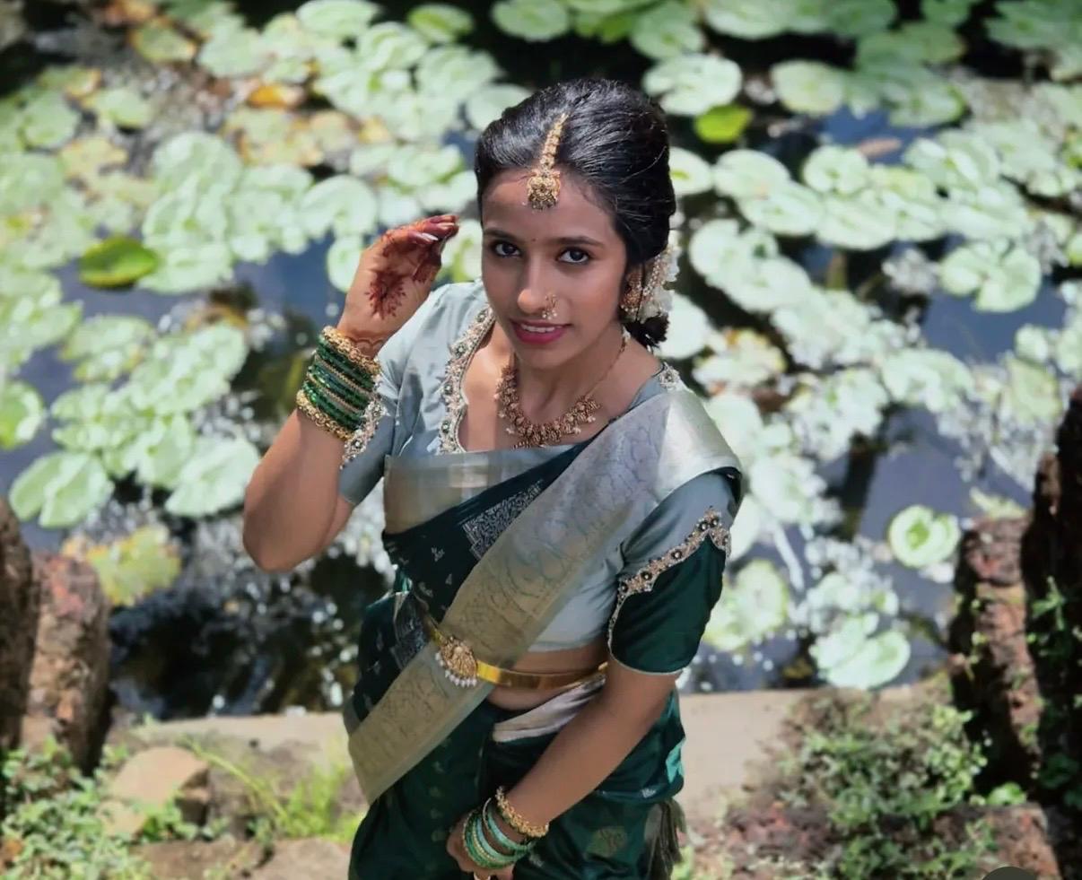 Sahuuu in a sari, smiling among lily pads