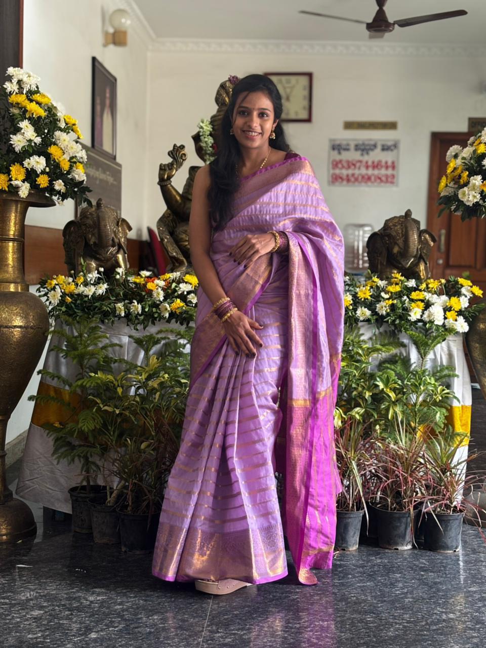 Sahuuu in a purple sari among flowers
